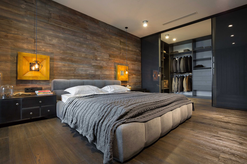 Petit dressing dans la chambre qui se ferme par des portes coulissantes en verre belle chambre homme célibataire loft