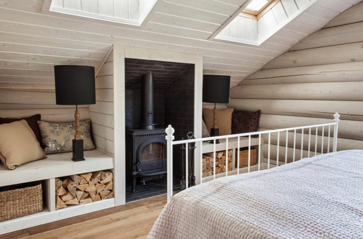 Poêle de chauffage dans la chambre aménagé sous le toit chambre à coucher design rustique