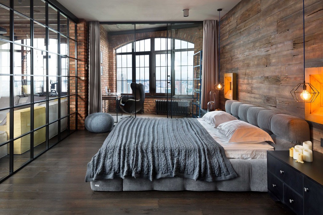 La seule chambre de ce loft industriel avec un grand lit moelleux grand lit chambre homme célibataire