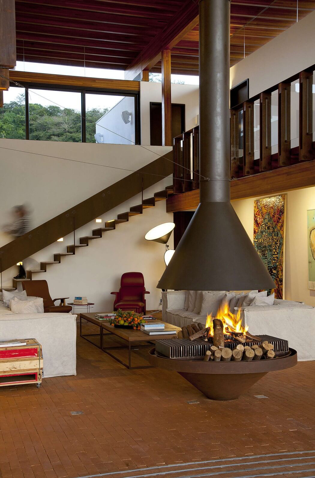 Le séjour et l’escalier menant vers l’étage formé en tant qu’anneau Belle cheminée de designer pour un séjour de luxe