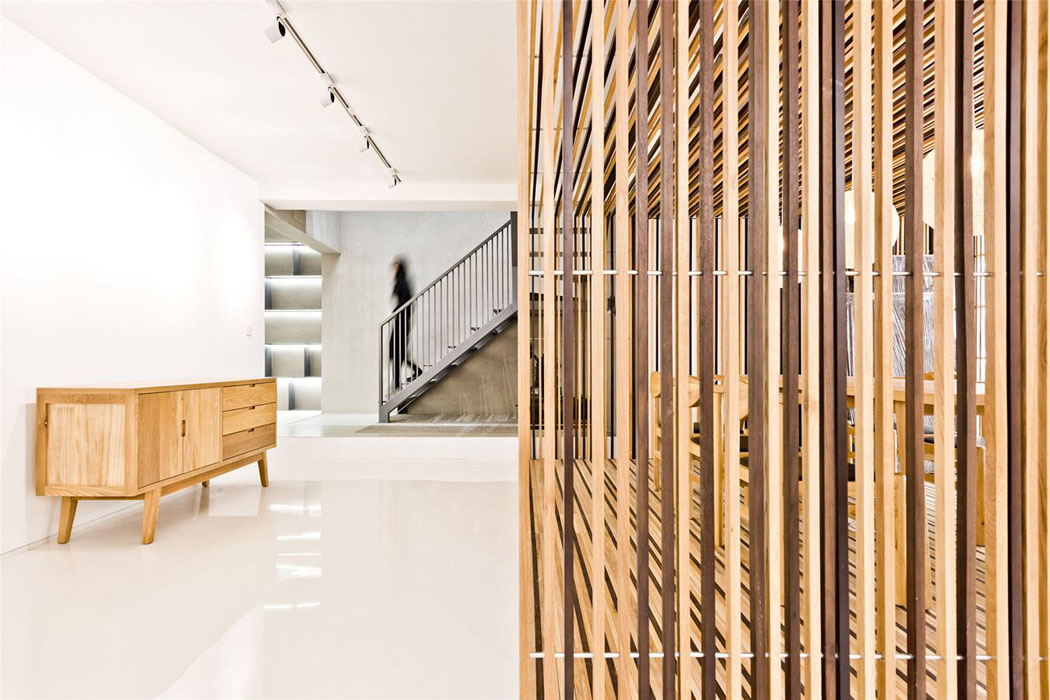 Après l’espace salle à manger place au couloir menant vers l’escalier intérieur accédant aux différents niveaux intérieur cloison bois massif design original