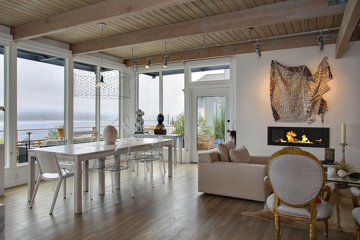 La cheminée qui est atout supplémentaire pour une ambiance cosy salle à manger avec vue sur la rivière décoration éclectique