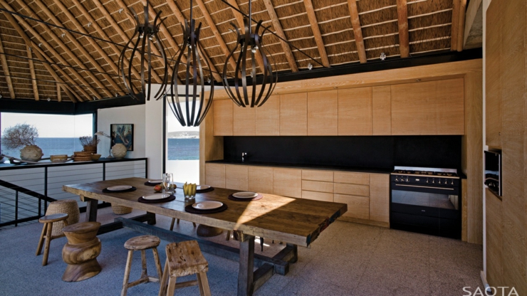 Côté salle à manger avec la cuisine ouverte aux placards intégrés terrasse design couverte luxe