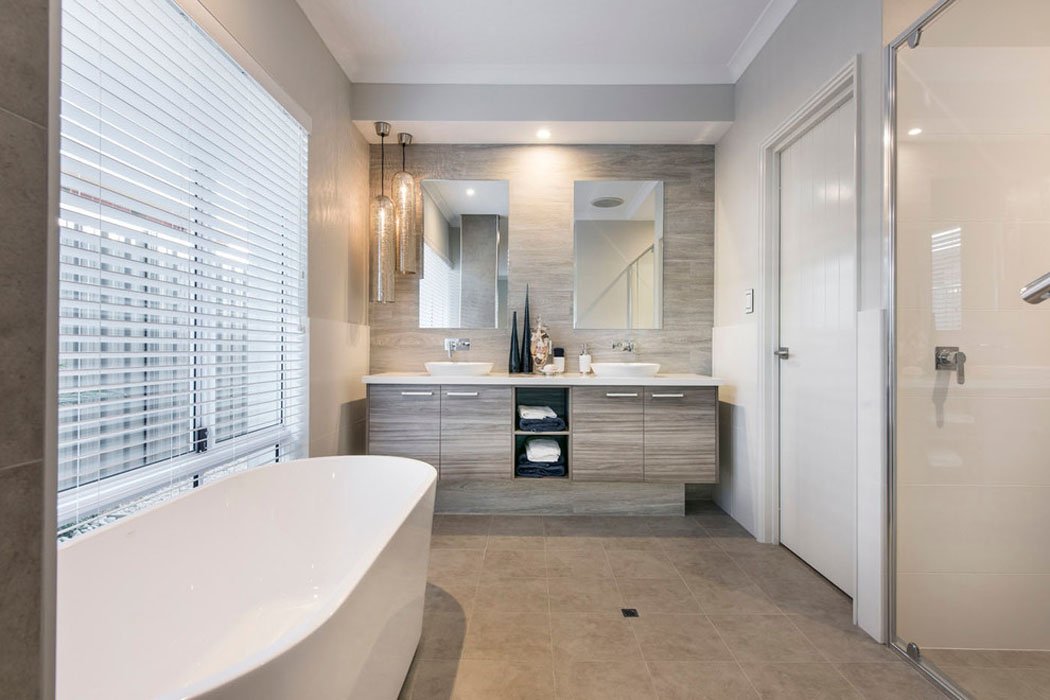 La salle de bains attenante à la chambre principale de cette maison de vacances baignoire douche petite salle de bains