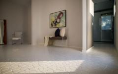 L’entrée et les couloirs de la résidence d’architecte suivent la même ligne minimaliste sol mosaïque carrelage de luxe en blanc