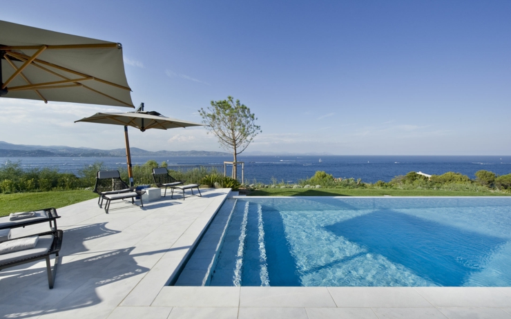 Piscine à débordement qui rejoint le bleu de la mer villa française de luxe côte d'azur